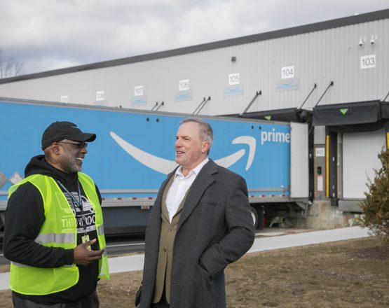 Alt text rec: Steve Williams, founder of Throneroom Delivery Service and Jeff Sullivan, CEO of New Valley Bank, in front of Amazon trailer Alt text rec: Steve Williams, founder of Throneroom Delivery Service and Jeff Sullivan, CEO of New Valley Bank, in front of Amazon trailer