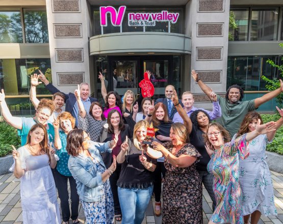 New Valley Bank leadership team celebrating outside the main office.