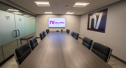 New Valley Bank boardroom with modern furnishings and branding.