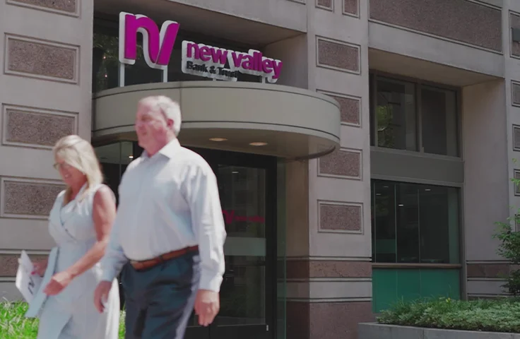 Two employees walking outside the New Valley Bank & Trust building in downtown Springfield.